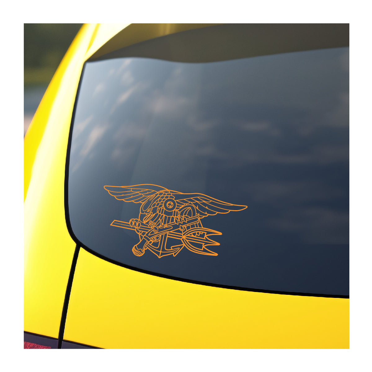 A yellow vinyl decal of the Navy SEAL Trident applied on the rear window of a yellow vehicle.