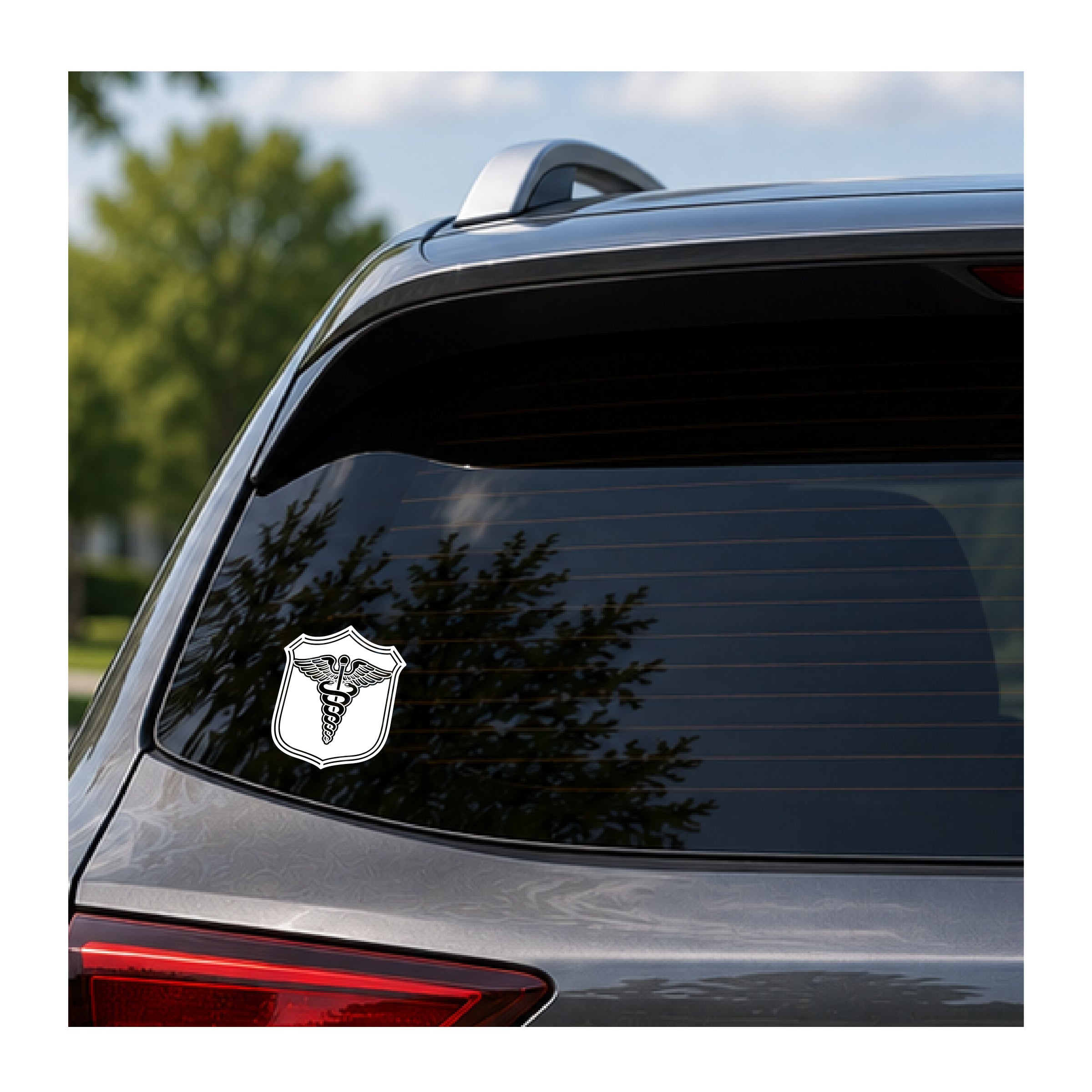 White Navy Medic Caduceus vinyl decal on a dark rear vehicle window