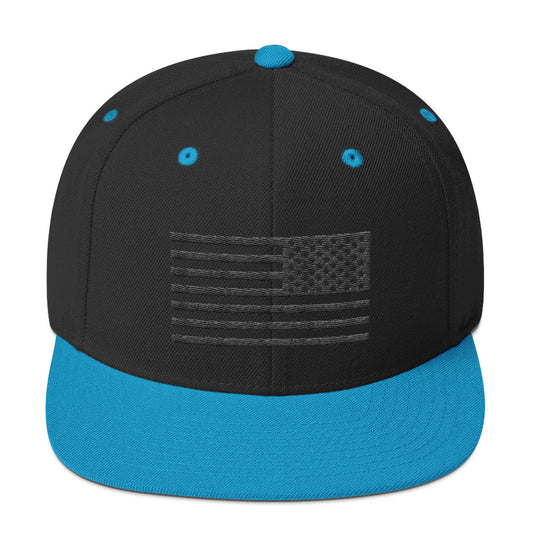 Black snapback hat with a blue brim featuring an embroidered US flag in black stencil on the front.